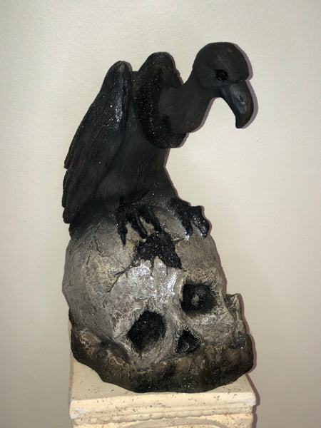 Vulture on skull figure